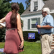 Brianna Wu (left) speaks with district resident and writer Tom Easton (right) after dropping of a campaign sign for him to host on his lawn.
